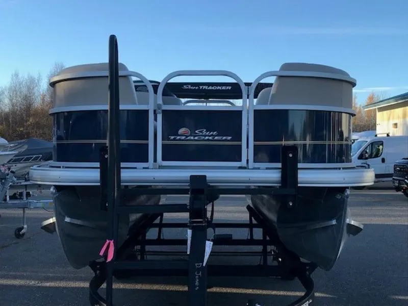 Slide: The Image of 2022 Sun Tracker PB 18 DLX pontoon boat on trailer, parked outdoors. - 11