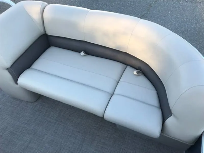 Slide: The Image of 2022 Sun Tracker PB 18 DLX boat seating, gray upholstery, curved design. - 14