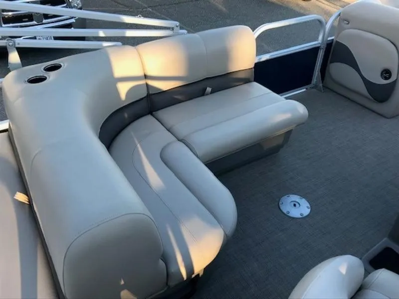 Slide: The Image of 2022 Sun Tracker PB 18 DLX pontoon boat interior with beige seating. - 7