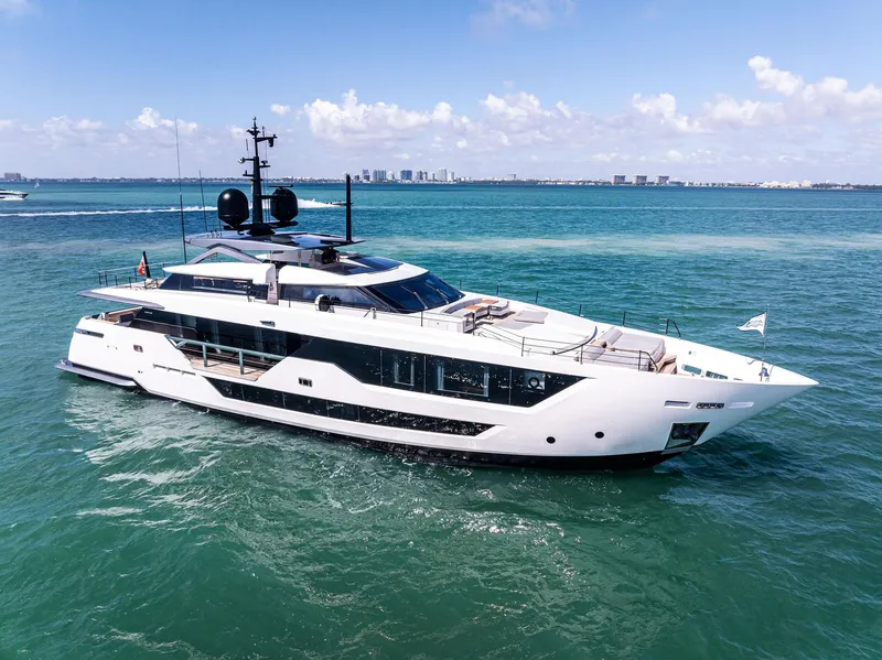 Slide: The Image of Luxury yacht Custom Line 106, 2022 model, cruising on clear blue waters. - 1