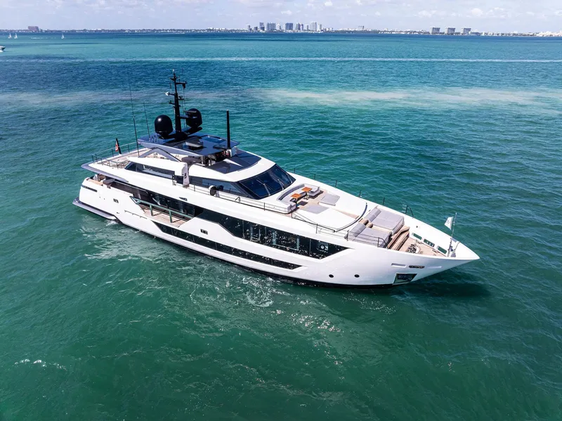 Slide: The Image of Luxurious 2022 Custom Line 106 yacht cruising on turquoise ocean waters. - 13