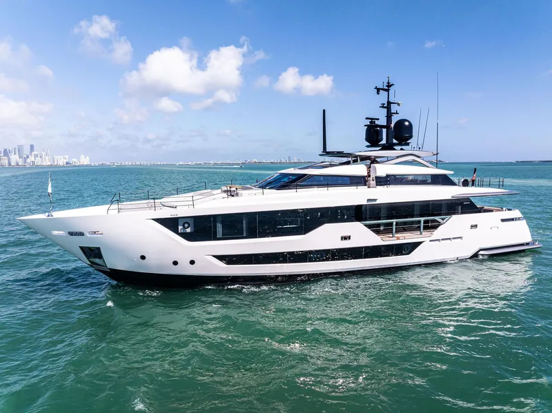 Slide: The Image of Luxurious 2022 Custom Line 106 yacht cruising on clear blue waters under a sunny sky. - 14