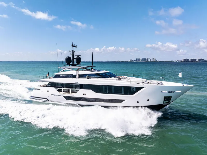 Slide: The Image of Luxurious 2022 Custom Line 106 yacht cruising on open sea under clear blue sky. - 17