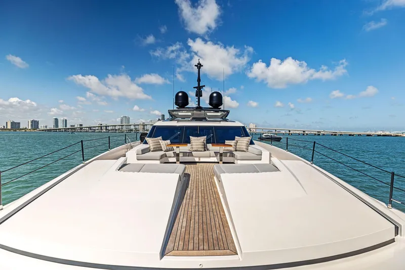 Slide: The Image of Luxurious 2022 Custom Line 106 yacht on open water with city skyline. - 26