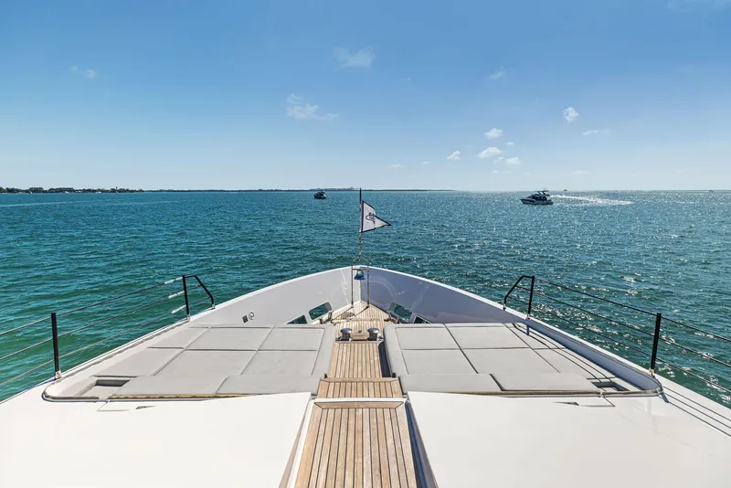 Slide: The Image of Custom Line 106 yacht deck overlooking serene ocean, 2022 model. - 29