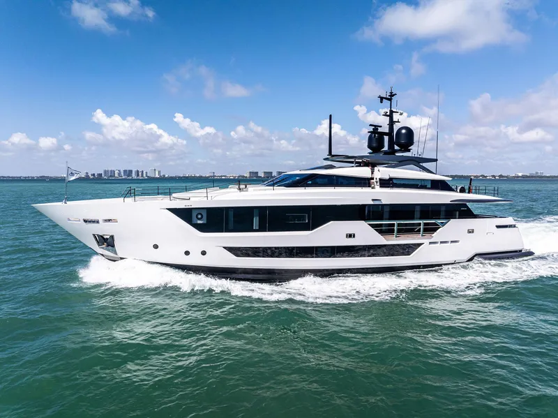 Slide: The Image of Luxurious 2022 Custom Line 106 yacht cruising on open water under a clear blue sky. - 3