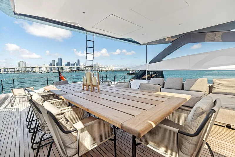 Slide: The Image of Luxury yacht deck with dining area, Custom Line 106, 2022, city skyline in background. - 37