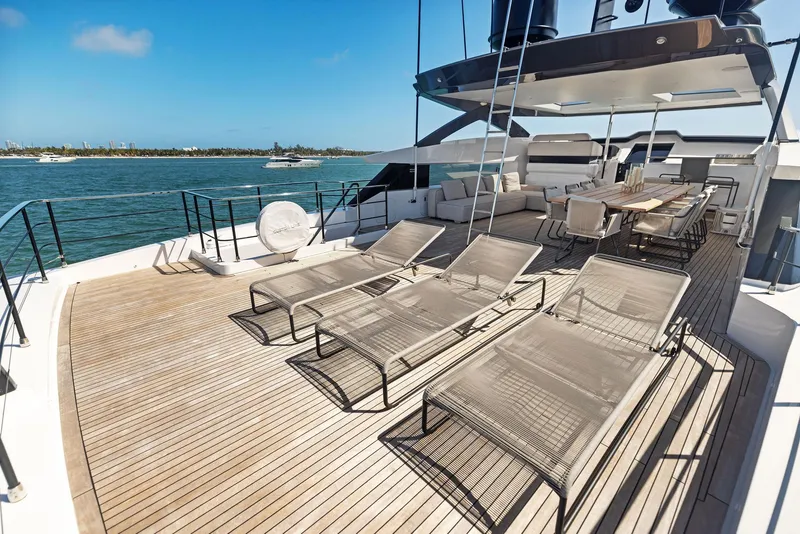Slide: The Image of Luxurious 2022 Custom Line 106 yacht deck with sun loungers and dining area. - 40