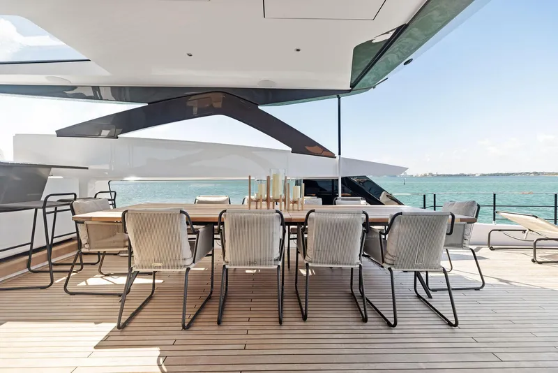 Slide: The Image of Luxury yacht deck with dining table, chairs, and ocean view, Custom Line 106, 2022 model. - 42