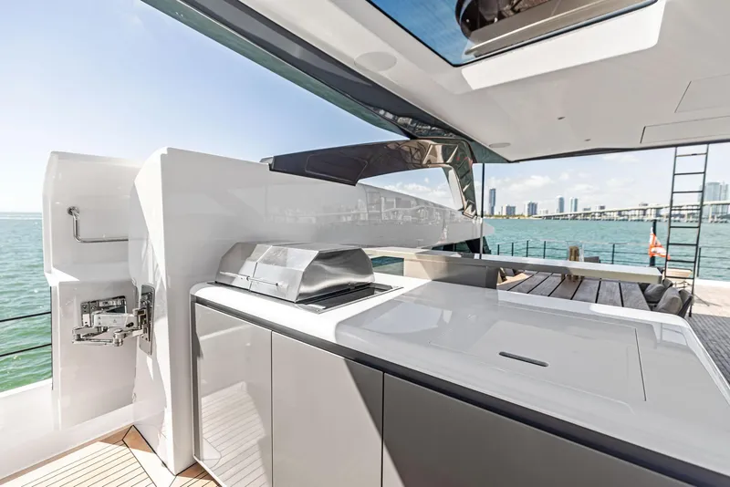 Slide: The Image of Luxury yacht Custom Line 106, 2022 model, featuring sleek outdoor kitchen and ocean view. - 48