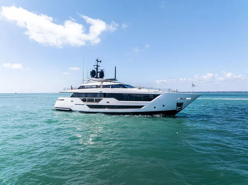 Slide: The Image of Luxurious 2022 Custom Line 106 yacht cruising on open sea under clear blue sky. - 6