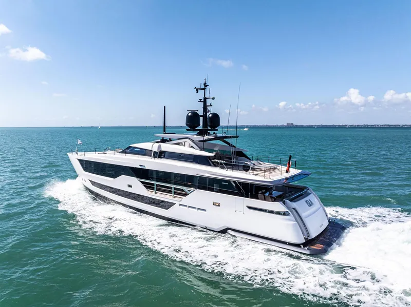 Slide: The Image of Luxurious 2022 Custom Line 106 yacht cruising on open sea under clear blue sky. - 7