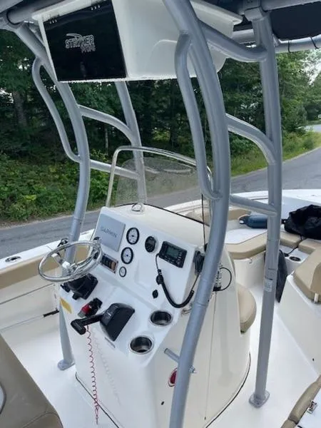 Slide: The Image of 2016 Key West 203FS boat console with steering wheel and gauges. - 4