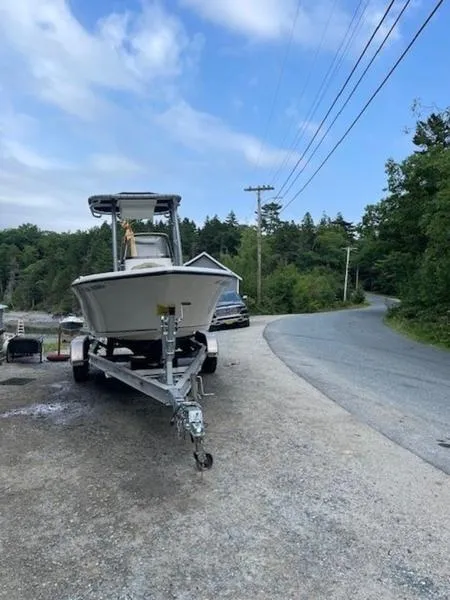 Slide: The Image of 2016 Key West 203FS boat on trailer near a scenic road. - 6