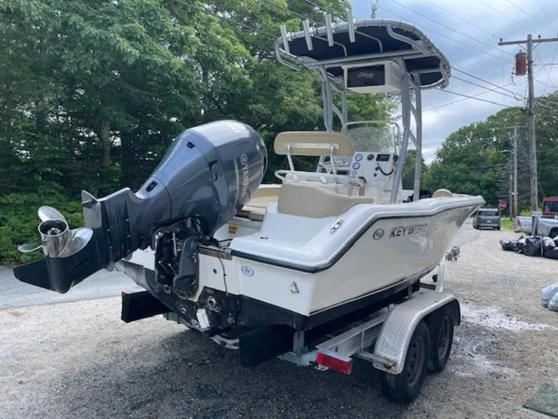 Slide: The Image of 2016 Key West 203FS boat on trailer with outboard motor, parked outdoors. - 7