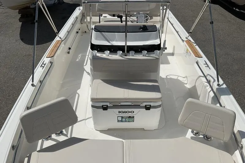 Slide: The Image of 2025 Boston Whaler 210 Montauk boat interior with seating and Igloo cooler. - 10
