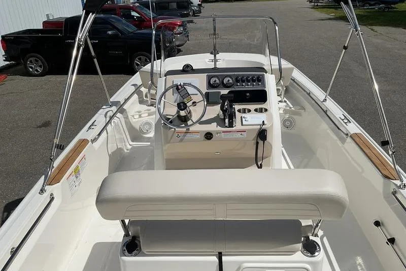 Slide: The Image of 2025 Boston Whaler 210 Montauk boat interior with steering console and seating. - 12