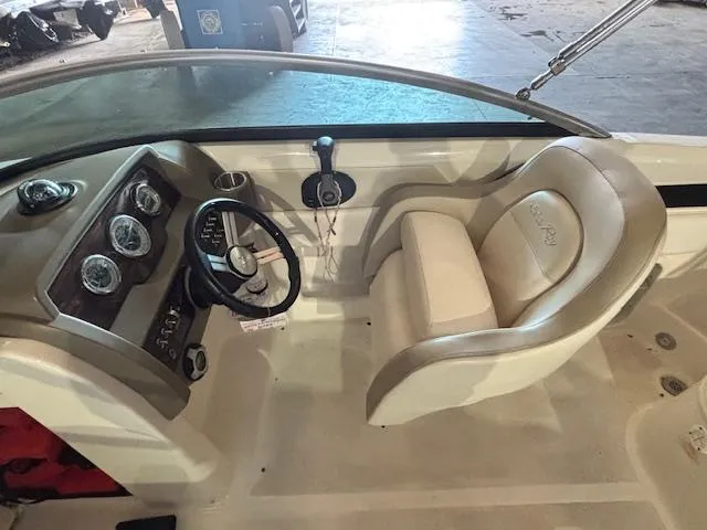 Slide: The Image of 2013 Sea Ray 220 Sundeck interior with steering wheel and dashboard controls. - 13