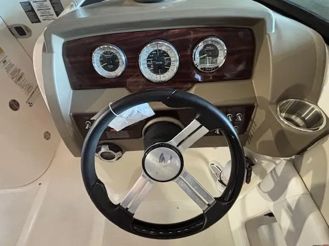 Slide: The Image of Steering wheel and dashboard of 2013 Sea Ray 220 Sundeck boat. - 14