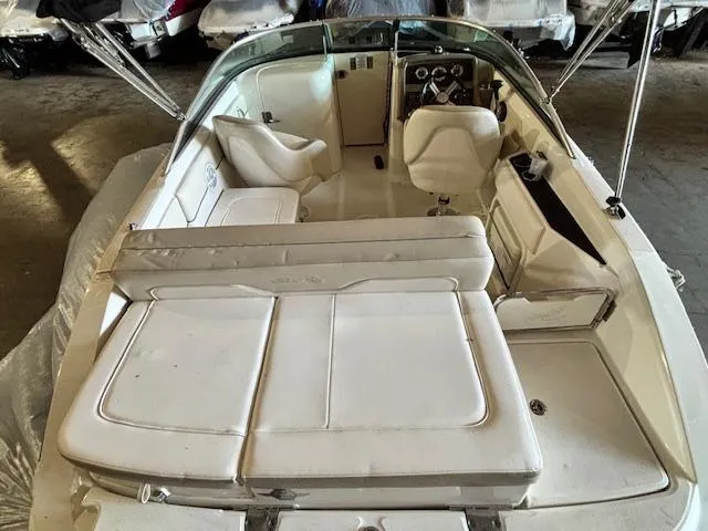 Slide: The Image of 2013 Sea Ray 220 Sundeck interior with white seating and steering console. - 6
