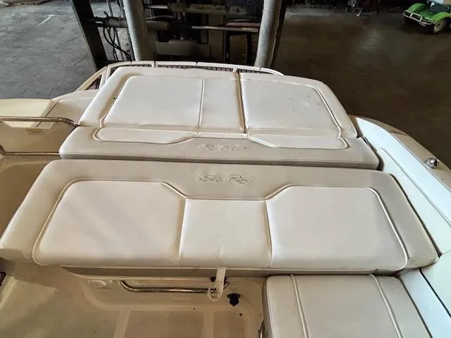 Slide: The Image of 2013 Sea Ray 220 Sundeck boat interior with white cushioned seating. - 8
