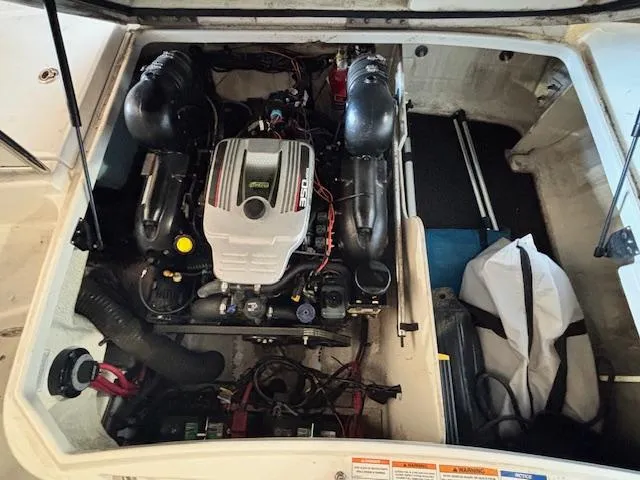 Slide: The Image of Engine compartment of a 2013 Sea Ray 220 Sundeck boat, showcasing the engine and components. - 9