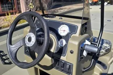 Slide: The Image of 2025 Tracker Grizzly 2072 CC boat dashboard with steering wheel and gauges. - 5