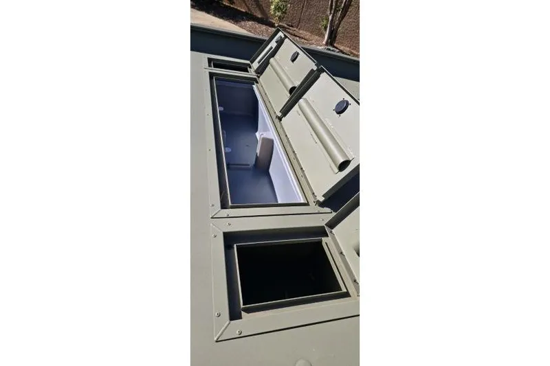 Slide: The Image of 2025 Tracker Grizzly 2072 CC boat storage compartments, open and empty. - 6