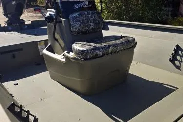 Slide: The Image of 2025 Tracker Grizzly 2072 CC boat interior with camo seating and console. - 7