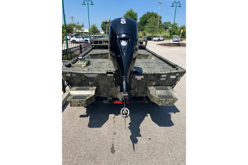 Slide: The Image of 2025 Tracker Grizzly 2072 CC Sportsman boat with camouflage design and powerful outboard motor. - 4