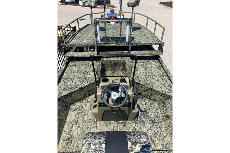 Slide: The Image of 2025 Tracker Grizzly 2072 CC Sportsman boat with camouflage design and central steering console. - 8