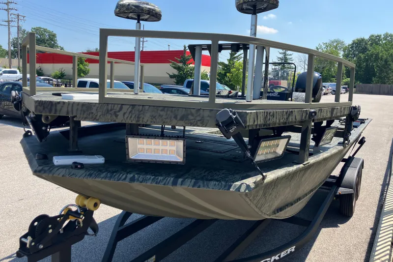 Slide: The Image of 2025 Tracker Grizzly 2072 CC Sportsman boat on trailer, featuring camouflage design and LED lights. - 3