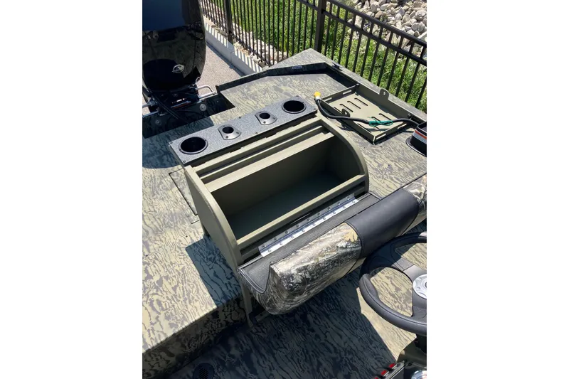 Slide: The Image of 2025 Tracker Grizzly 2072 CC Sportsman boat interior with storage and cup holders. - 11