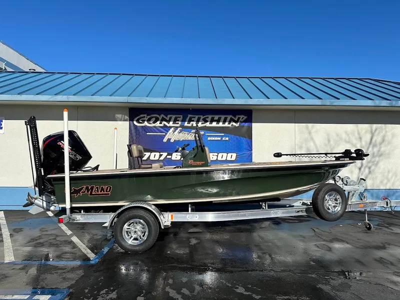 The Image of 2025 Mako 18 Pro Skiff Backwater Edition boat on trailer, parked outside dealership. - 0