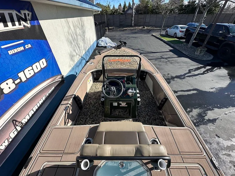 Slide: The Image of 2025 Mako 18 Pro Skiff Backwater Edition boat parked outdoors, showcasing interior and steering console. - 12