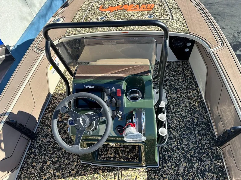 Slide: The Image of 2025 Mako 18 Pro Skiff Backwater Edition boat interior with steering console and controls. - 13