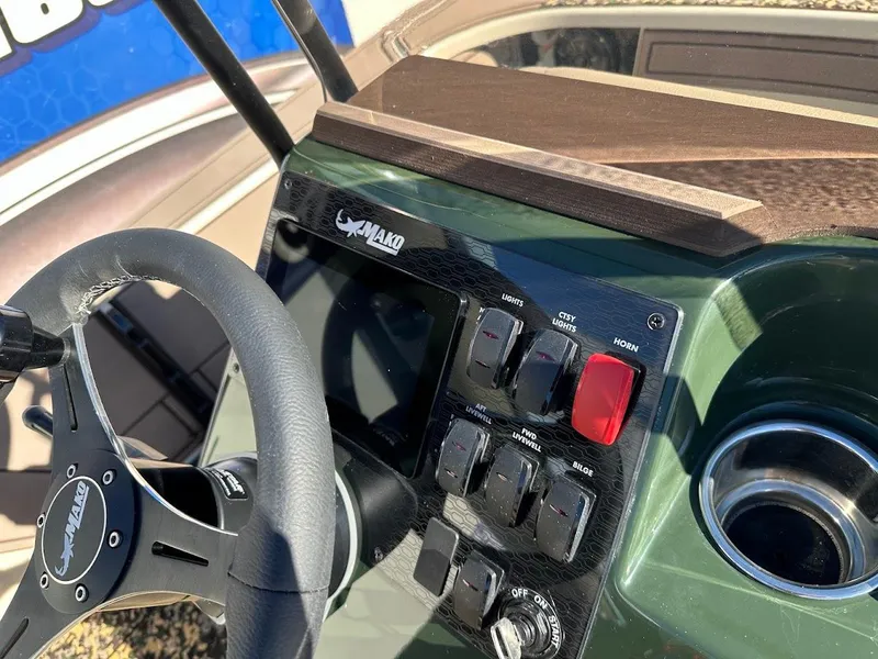 Slide: The Image of Control panel of 2025 Mako 18 Pro Skiff Backwater Edition boat with steering wheel. - 14