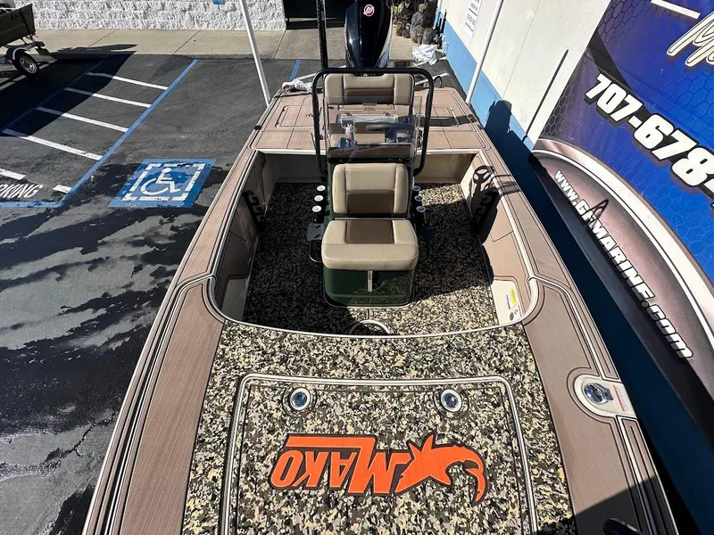 Slide: The Image of 2025 Mako 18 Pro Skiff Backwater Edition with camo deck, parked in a lot. - 16