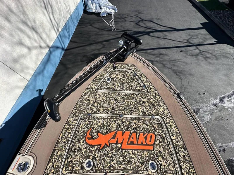 Slide: The Image of 2025 Mako 18 Pro Skiff Backwater Edition boat with camo deck and logo. - 18