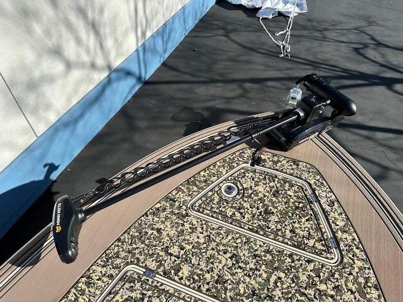 Slide: The Image of 2025 Mako 18 Pro Skiff Backwater Edition with camouflage deck and trolling motor. - 19