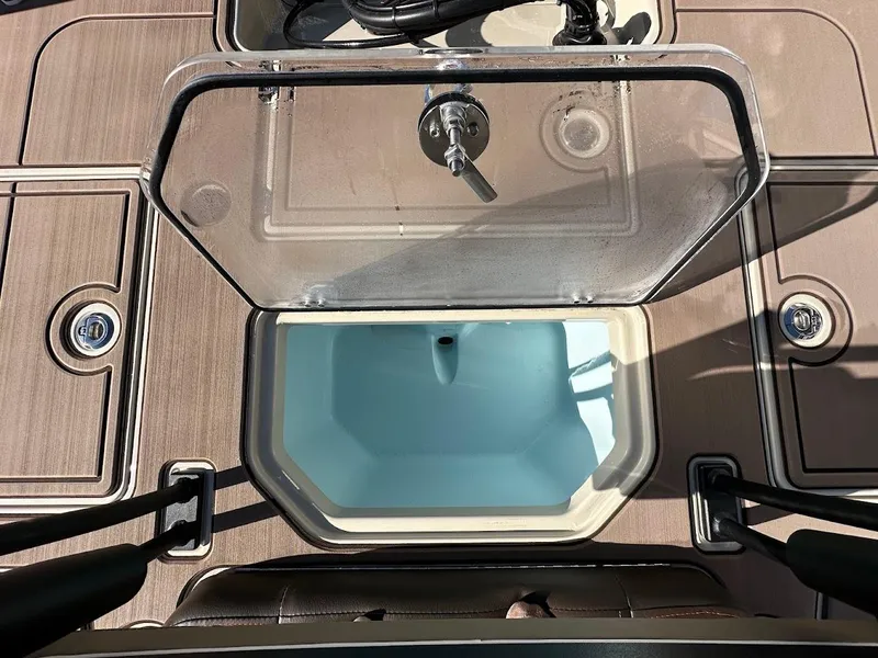 Slide: The Image of 2025 Mako 18 Pro Skiff Backwater Edition livewell with open lid, showcasing interior. - 27