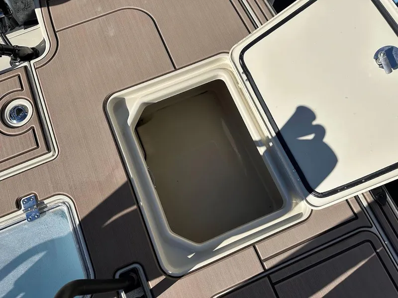 Slide: The Image of Open storage compartment on 2025 Mako 18 Pro Skiff Backwater Edition boat deck. - 28