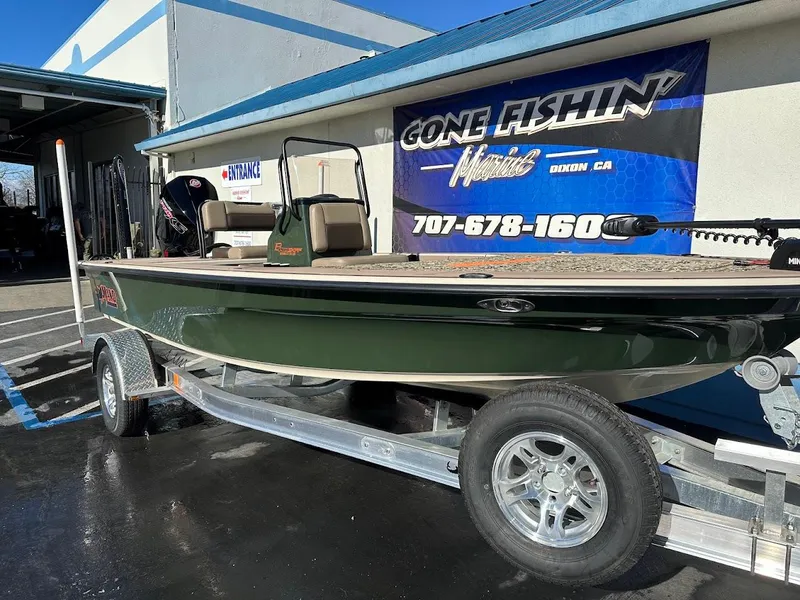 Slide: The Image of 2025 Mako 18 Pro Skiff Backwater Edition on trailer outside dealership. - 5