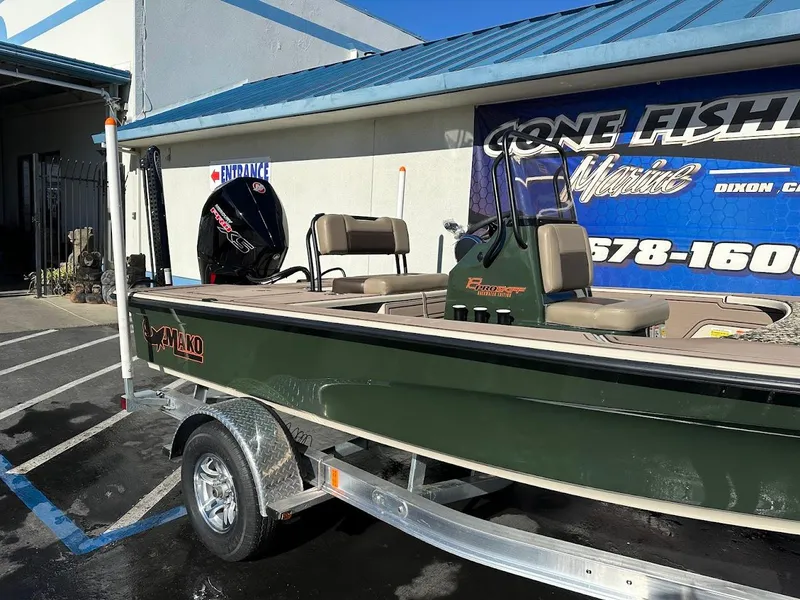 Slide: The Image of 2025 Mako 18 Pro Skiff Backwater Edition boat on trailer outside a fishing store. - 6