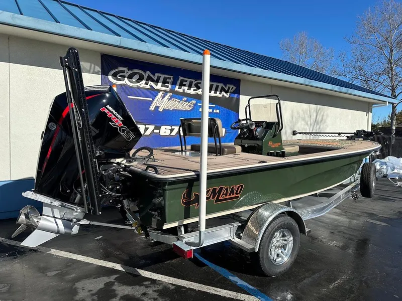 Slide: The Image of 2025 Mako 18 Pro Skiff Backwater Edition boat on trailer, displayed outdoors. - 8