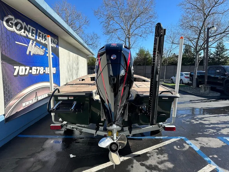 Slide: The Image of 2025 Mako 18 Pro Skiff Backwater Edition boat in parking lot, rear view. - 9