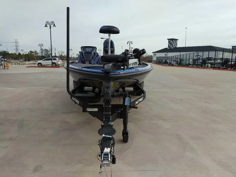 Slide: The Image of 2025 Nitro Z21 XL boat on trailer in parking lot. - 2