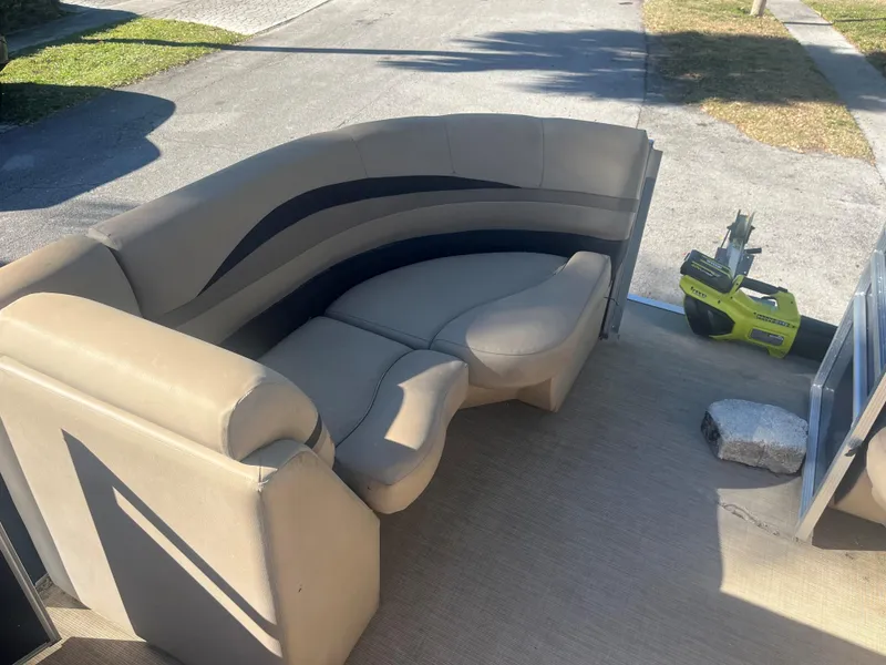 Slide: The Image of 2017 Crestliner 200 RALLY boat interior with beige seating and outdoor setting. - 5
