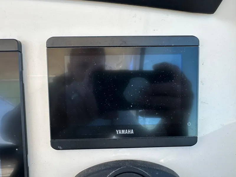Slide: The Image of Yamaha display screen on 2023 Sailfish 245 DC boat dashboard. - 24