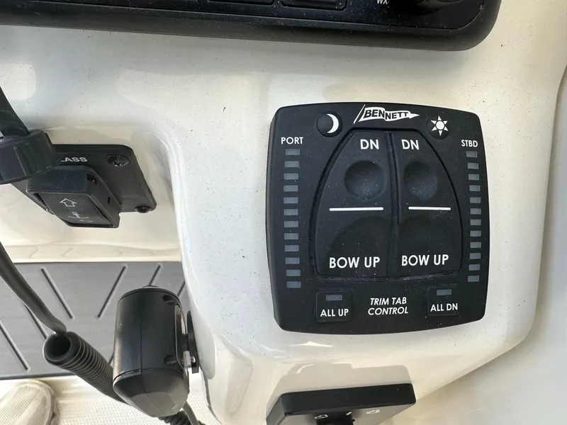 Slide: The Image of Bennett trim tab control panel on 2023 Sailfish 245 DC boat. - 27